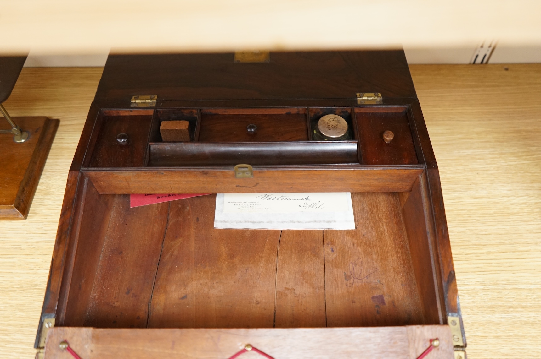 A tooled leather writing slope, a letter rack and postage scales, largest 37cm wide